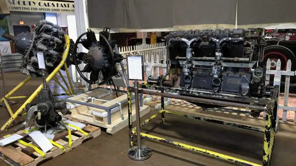 Vintage radial and inline engines braced on pallets and stands on the warehouse floor