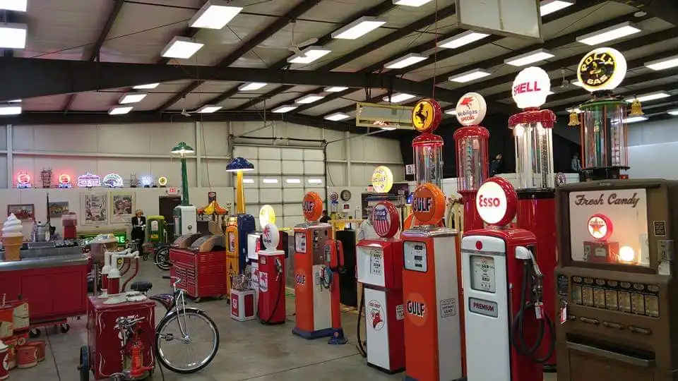 A collection of restored vintage gas pumps and signage stored inside the Las Vegas Warehouse